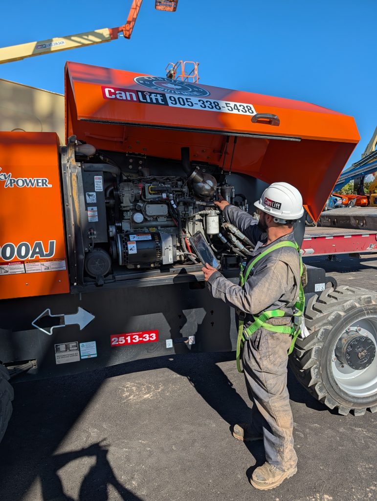 CanLift shop technician Shawn Down using Keycard's AI-powered tools to diagnose a JLG boom lift repair